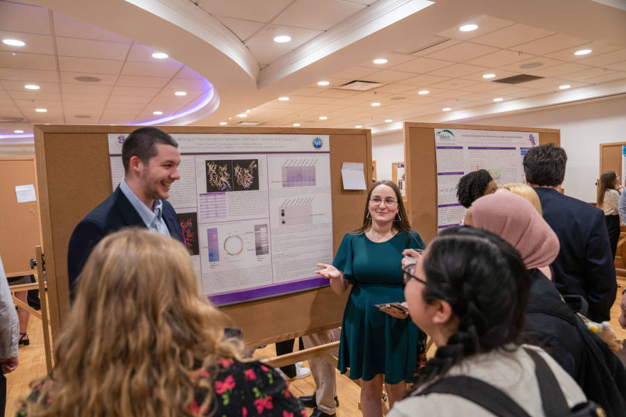 A student presents during the poster segment of the Undergraduate Research Conference.