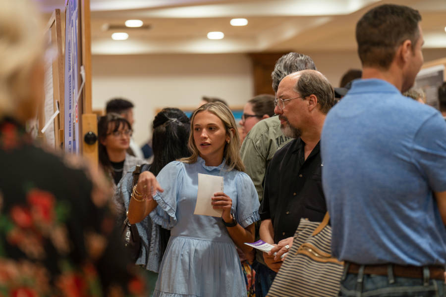 A student presents during the poster segment of the Undergraduate Research Conference.