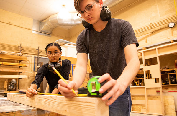 Students measuring wood