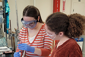 Students measuring chemicals