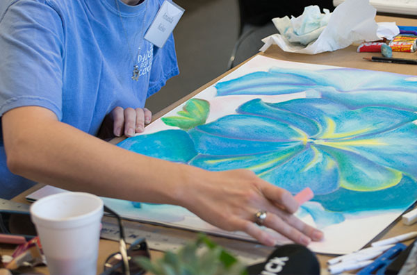 Student creating a colorful art piece