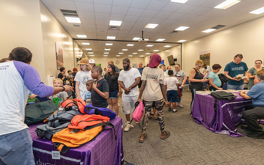 Participants arriving at the Back to School Bash event