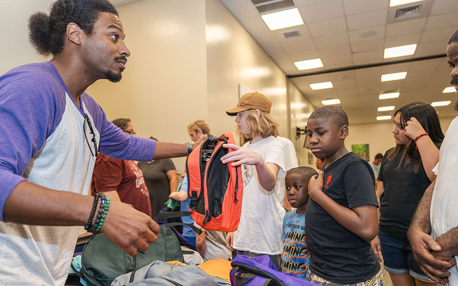 Handing out school supplies at the Back to School Bash event