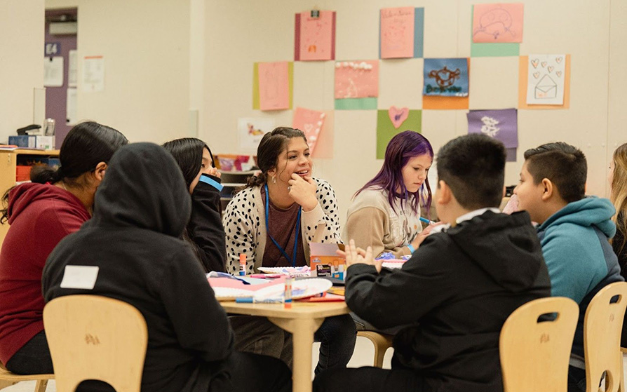 Students talking at a table