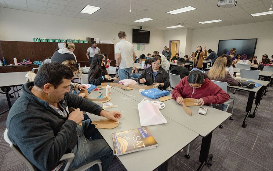 Parents and students working on project at an LLA event