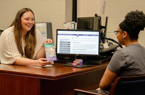 Advisor talking with student