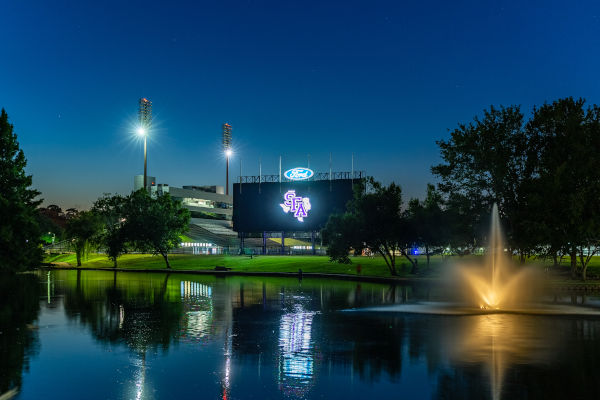 Ag pond and scoreboard at dusk
