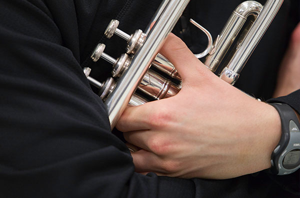 close up of person holding a trumpet