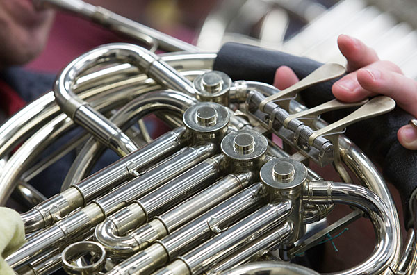 close up of person playing French horn
