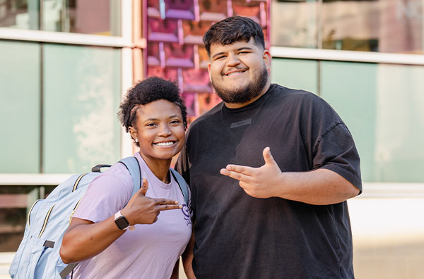 Students standing in front of Griffith Fine Arts building