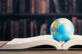 open history textbook with globe
