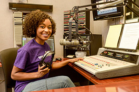 smiling girl at audio mixer