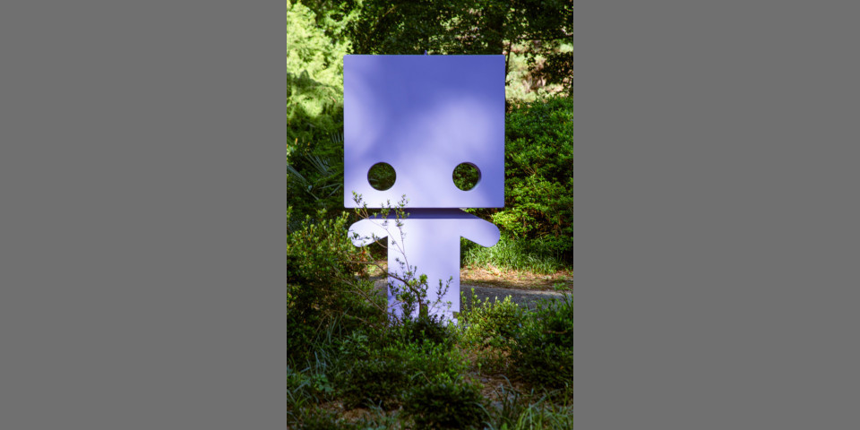 A blocky sculpture of a robot in the SFA Gardens