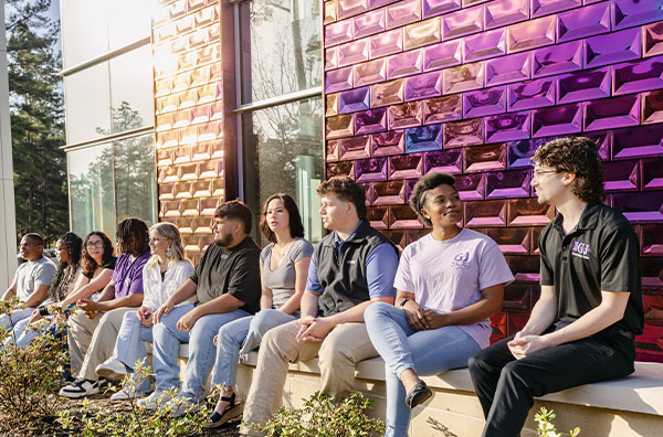 Students sitting on wall