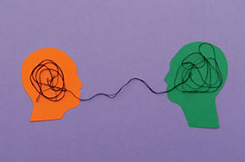 a drawing of two facing heads with lines drawn from brainks to mouths