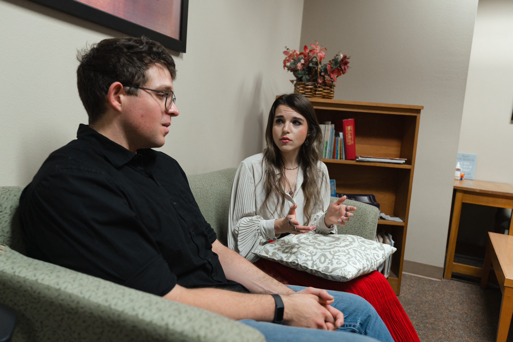 students sitting on couch talking