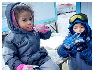 Children eating icicles
