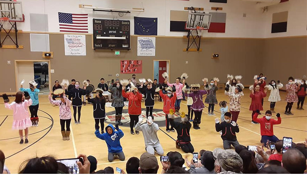 Parents of children who are participating in their first Alaska Native dance performance give small gifts to the elders as a wish for good health and wellbeing. For Teddy’s first performance, Céspedes made the elders gift bags with touch gloves and cookies.