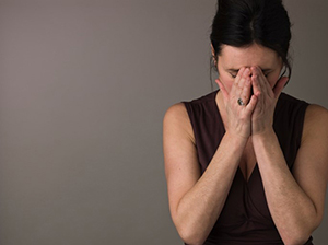 woman with face in hands