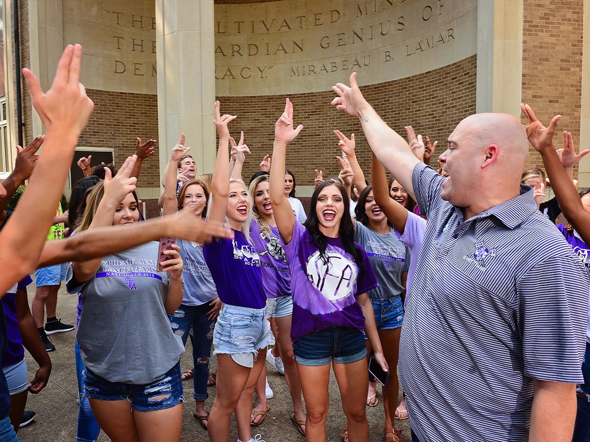 Maple and members of the SFA Spirit Teams gather outside the Boynton Building in 2019 for a photoshoot. Photo by Hardy Meredith '81