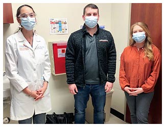 Brandon and Wendi Hawthorne pose with Dr. Netanya Utay, an associate professor of general internal medicine at UTHealth, at their final efficacy appointment.