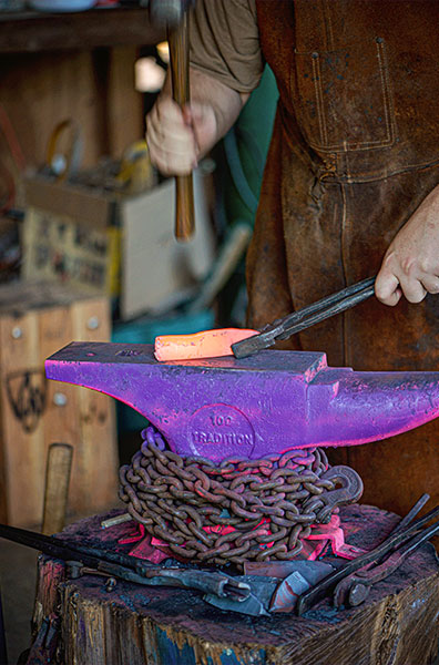 Burgess beats the pliable steel with the help of a steel hammer and a cast iron anvil.