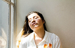 woman in looking out window