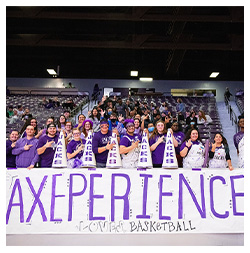 Students smiling with sign