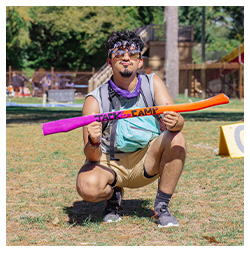 Student posing with an axe handle