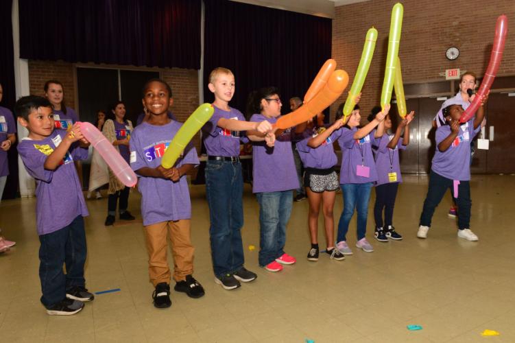 Area second-graders learning about elasticity and electriciy using balloons.