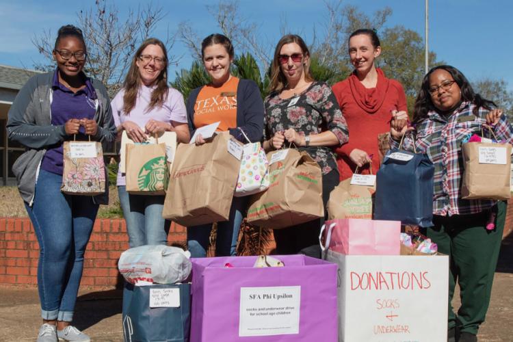 Sierra Smith, Phi Upsilon Omicron president and a hospitality administration senior from McKinney; Tracie Estepp, Phi Upsilon Omicron vice president and a food, nutrition and dietetics senior from Georgetown; and NISD social workers Lauren Ivy Sieja, Ashley Helmer, Catie Munguia and Kiesha Tutt.