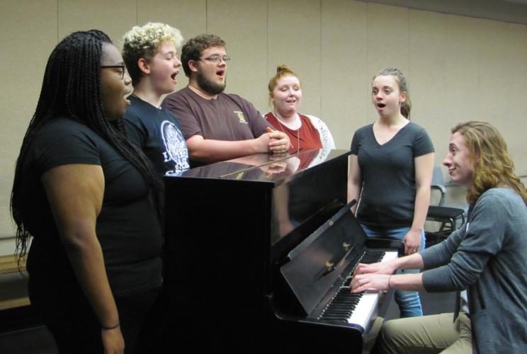 Student chorus members for the SFA School of Theatre’s presentation of “(Biedermann and) The Firebugs” reharse with junior music composition major Jesse Edwards, who has written the music for the show.