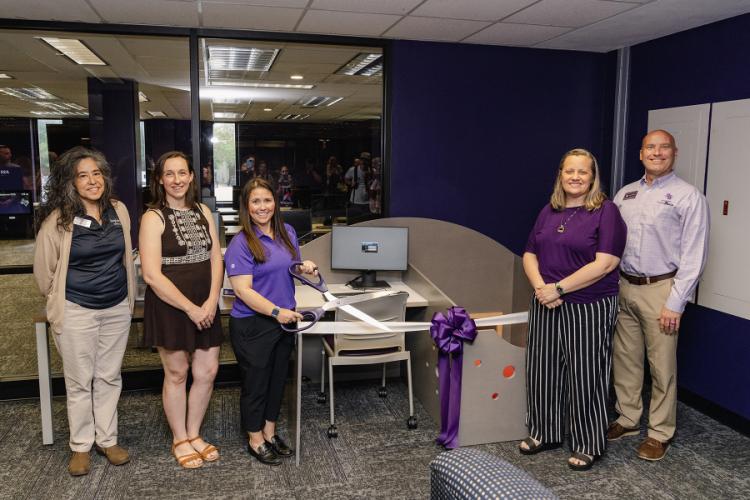 Members from SFA and the Nacogdoches community present a family-friendly workstation during a ribbon-cutting event