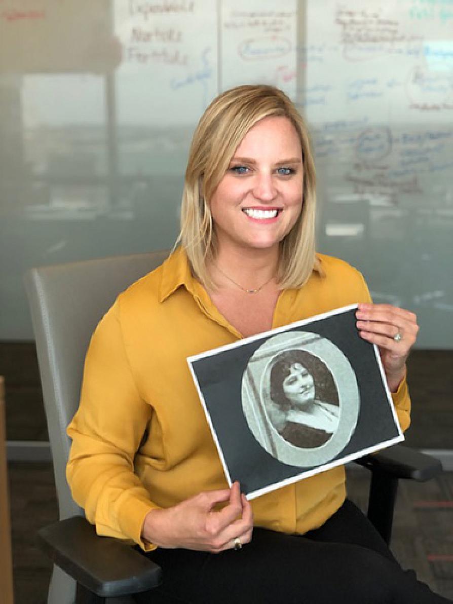 Heather Dulin holds a photograph of her great-grandmother, Ibby Inez Fuller