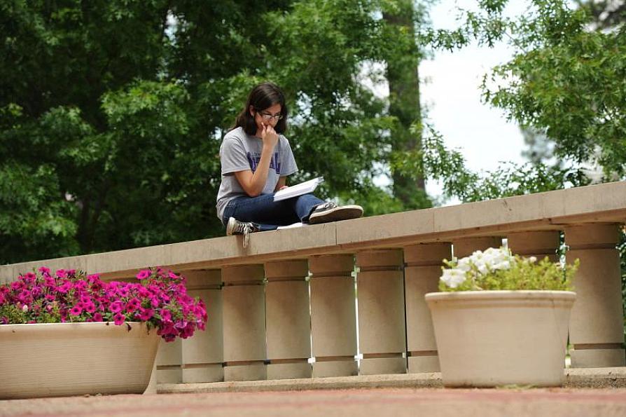 a student reviewing an assignment outside