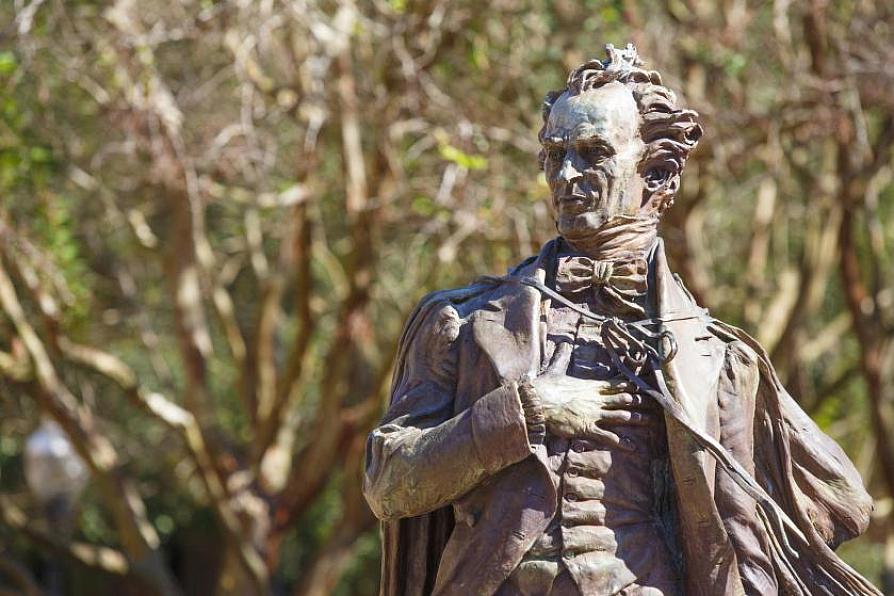 Close-up view of the statue of Stephen F. Austin with his hand across his chest