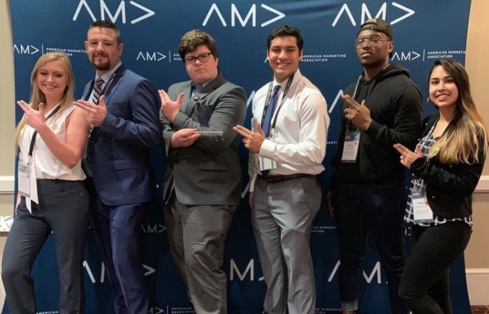 Students posing with award